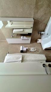 a bathroom with a sink and a toilet and towels at Hotel Alysa Korce in Korçë +43 photos