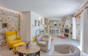 a living room with yellow chairs and a table at Lovely Home In Selina in Selina