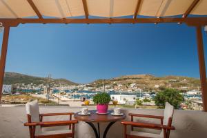 a table with two chairs and a view of a city at Stefanos Studios in Skala