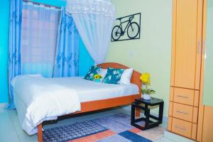 a bedroom with a bed and a bike on the wall at Cozy 1Bedroom Apartment, Machakos Town in Machakos