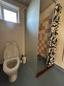 a bathroom with a toilet and a window at Ilulissat Stay - Siku in Ilulissat +20 photos