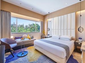 Voodi või voodid majutusasutuse Vivanta Bengaluru Residency Road toas