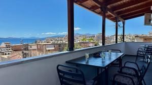 a table and chairs on a balcony with a view at Thea Penthouse with private parking in Sarandë