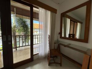 a bathroom with a large mirror and a window at Balcony Living Apartment in Seminyak +22 photos