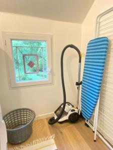 a room with a vacuum cleaner and a window at Appartement Atypique- Esprit Atelier Loft - parking privé - Wifi - vidéo in Amiens +29 photos