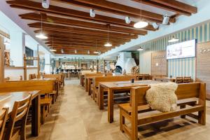 a dining room with wooden tables and chairs at Apartmány Sport & Ski in Stará Turá