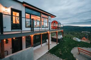 a house with a balcony and a bench on a hill at Ski Chalet with Spa - Mountain - La Boheme in Saint Come