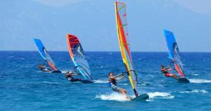 a group of people windsurfing in the ocean at Wild Roots Mirissa in Mirissa