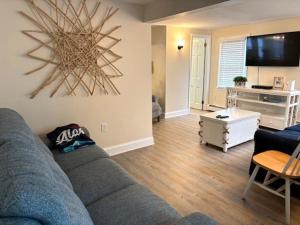 a living room with a couch and a tv at Just Moments From The Causeway Bridge This Charming Spacious Five-Bedroom 2 Bath Home Is Located In Ship Bottom On The Island Of Lbi Wifi in Ship Bottom