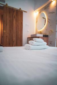 a stack of towels on a bed in a bathroom at Azur Pietra in Menton