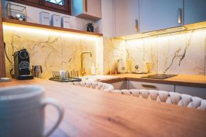a kitchen with a counter and chairs in a room at Azur Pietra in Menton
