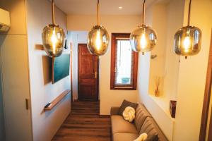 a living room with a couch and several lights at Azur Pietra in Menton