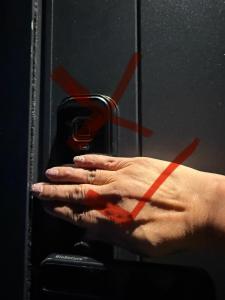 a hand holding a cell phone in front of a mirror at Apartment on Short ! in Christchurch