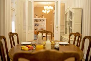 a dining room table with fruit and drinks on it at Chillinn La Maison Cottage Eger in Eger