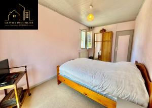 a small bedroom with a bed and a desk at Le Montagnard in Marignier