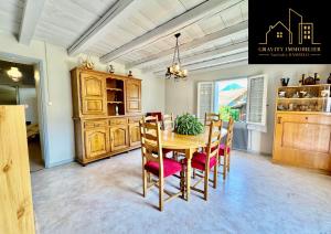 a dining room with a wooden table and chairs at Le Montagnard in Marignier +7 photos