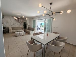 a dining room with a white table and chairs at Apartment Del Mar in Novi Vinodolski