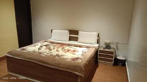 Postel nebo postele na pokoji v ubytování Hotel Om Complex