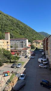 a parking lot with cars parked in front of a mountain at Apartament Herculane cu vedere la munte in Băile Herculane