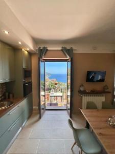 a kitchen with an open door to a balcony at Isoco House in Taormina