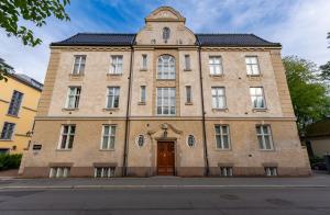 an old brick building with a door on a street at The Apartments Company - The Sweet in Oslo