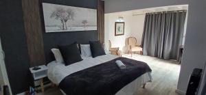 a bedroom with a large bed with black and white sheets at Reef View BnB in East London