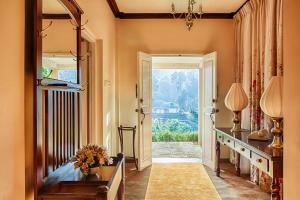 a hallway with a table and a door with a window at Jetwing Oatlands Bungalow - Whole Villa in Nuwara Eliya