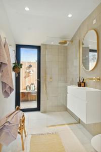 a bathroom with a sink and a mirror at Relaxed Lifestyle And Luxury In Melby in Melby