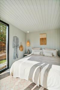 a bedroom with a large white bed and a window at Relaxed Lifestyle And Luxury In Melby in Melby