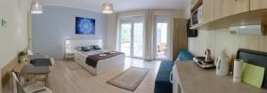 a large room with a bed and a living room at Szíriusz Apartmanház in Gyula