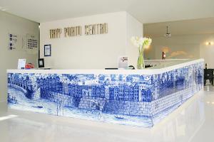 a large blue and white decorated room with a clock on the wall at TRYP by Wyndham Porto Centro Hotel in Porto