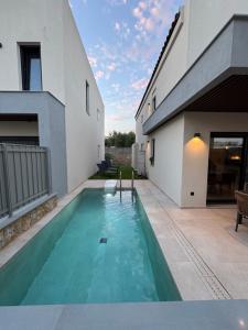 a swimming pool in the backyard of a house at Villa El Mar in Gerakini