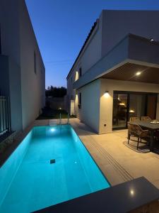 a swimming pool in front of a house at Villa El Mar in Gerakini +28 photos
