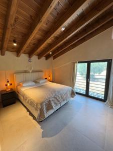 a bedroom with a bed and a large window at Villa El Mar in Gerakini