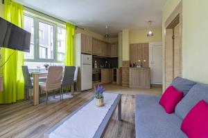 a living room with a couch and a table at My Space Deluxe One Bedroom Apartment in Sofia