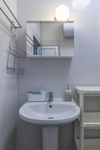 a bathroom with a white sink and a mirror at My Space Deluxe One Bedroom Apartment in Sofia