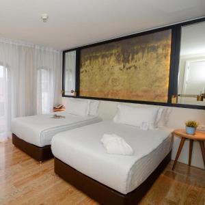 a bedroom with two beds and a painting on the wall at Miapera Hotel & Spa - Special Class in Istanbul