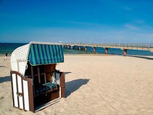 a life guard stand on a beach with a pier at Meerblick 5 - Großenbrode in Grossenbrode