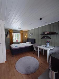 a bedroom with a bed and a table and a couch at Jävregården in Jävre
