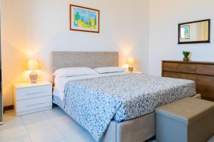 a bedroom with a bed and two night stands and two lamps at Villa Fausta in La Maddalena