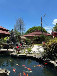 a garden with a pond with kites in it at Temple Stay - Diem Phung Pagoda 