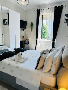 a bedroom with a bed with pillows and a window at Loft NUOVO vicino al centro - OASI Relax in Turin