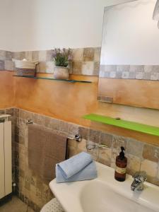 a bathroom with a sink and a mirror at Heleni Apartment in Tortoreto Lido +11 photos