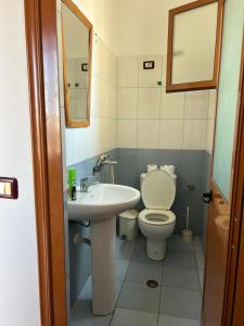 a bathroom with a toilet and a sink at Begaj Rooms in Durrës
