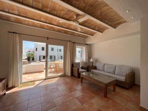 a living room with a couch and a table at Sa TORRE 2 by SOM Menorca in Fornells