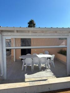 a patio with a table and chairs on a deck at Villa Gioia in Villaggio Peruzzo