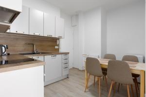 a kitchen with a table with chairs and a sink at Apartment with 2 bedrooms with kitchen near metro in Prague