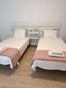 two beds sitting next to each other in a room at Villa Lele in Playa Blanca