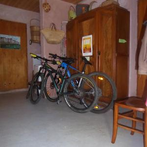 two bikes parked next to each other in a room at chambre d'hôte calme au milieu d'un jardin au Freney d'oisans in Le Freney-dʼOisans