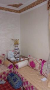 a living room with a couch and a table at دار السياحة in Larache